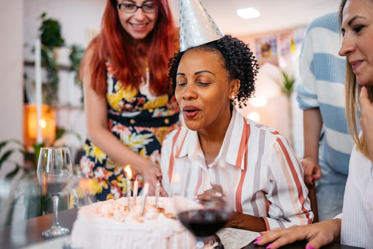 Person holding birthday cake with candles